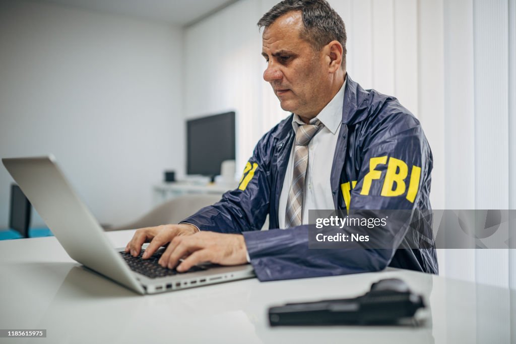 a-senior-fbi-agent-uses-a-laptop-in-the-office.jpg