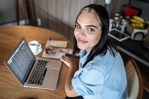 portrait-of-a-transgender-woman-using-laptop-or-working-at-home.jpg