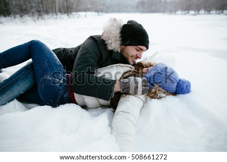 stock-photo-happy-couple-having-fun-playing-in-the-snow-on-a-cold-winter-day-508661272.jpg
